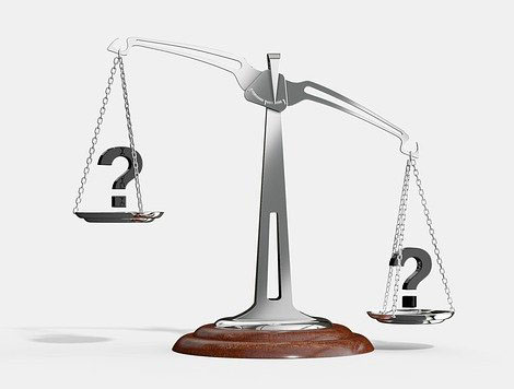 a scale weighing question marks